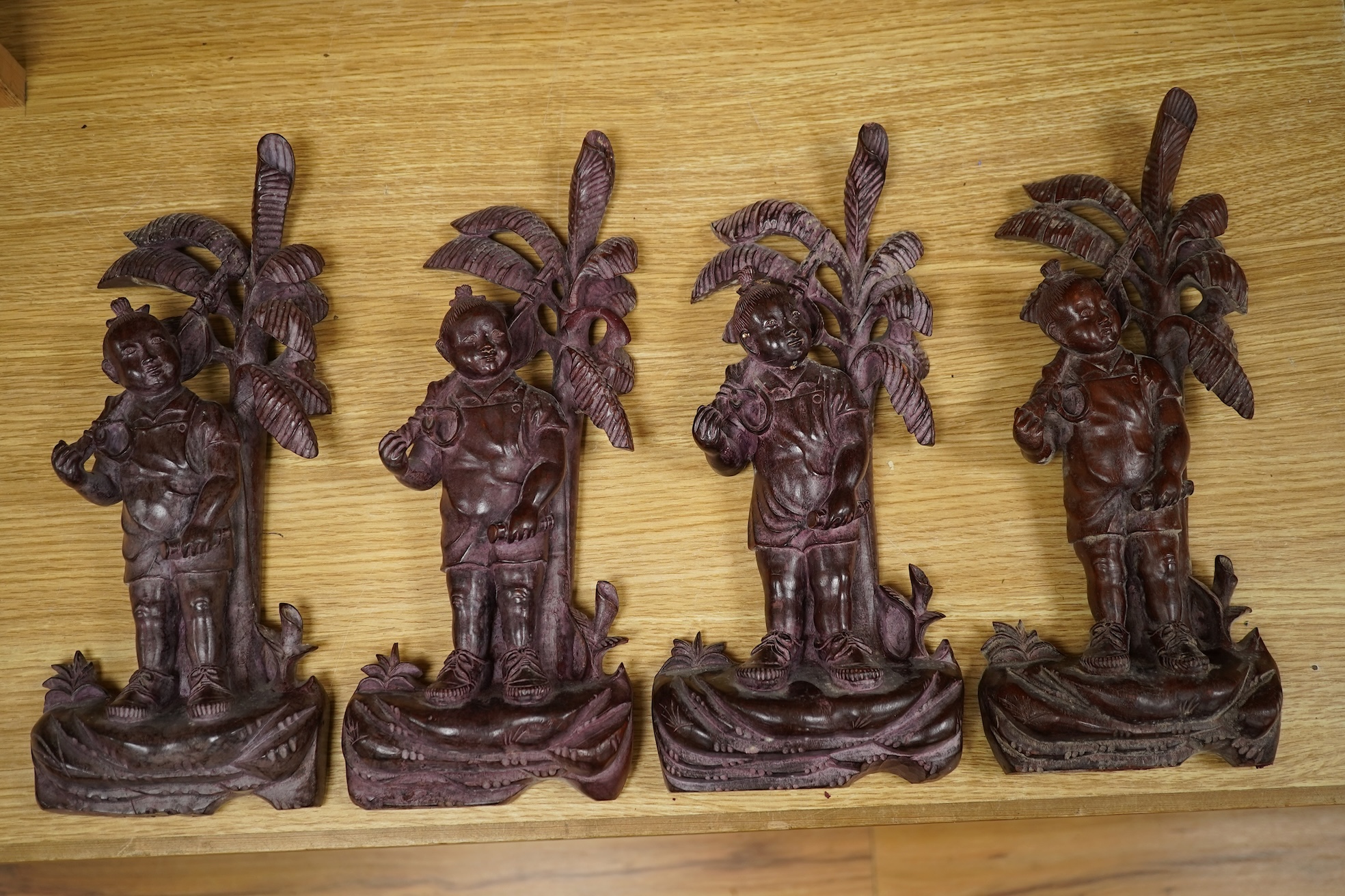 Four 1960's Chinese Cultural Revolution figures of boys holding a rifle, 33cm high